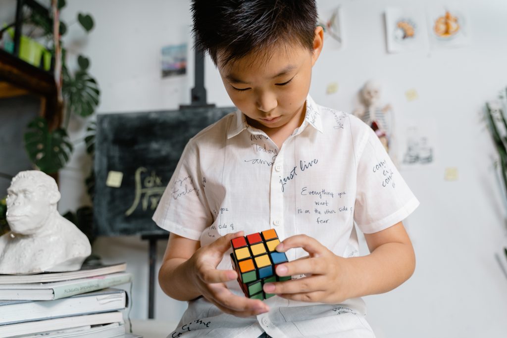 boy solving a rubiks cube